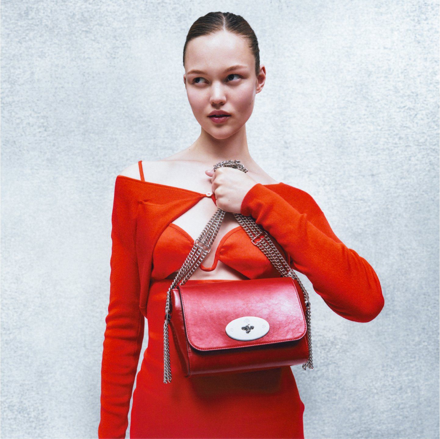 Model holding Mulberry Triple Chain Lily bag in red